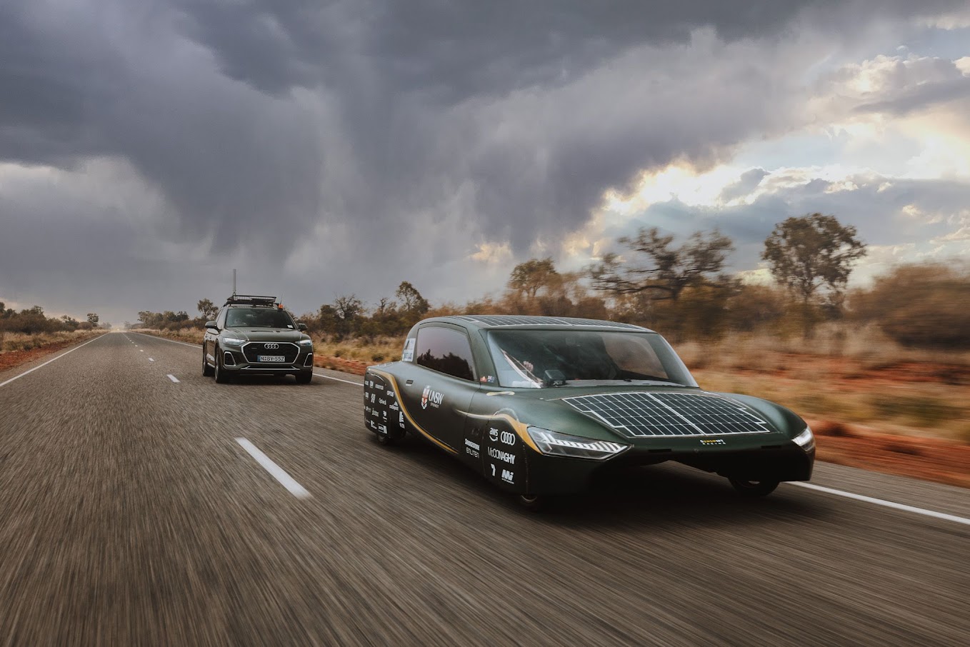 Sunswift 7 racing on the highway ahead of its chase vehicle