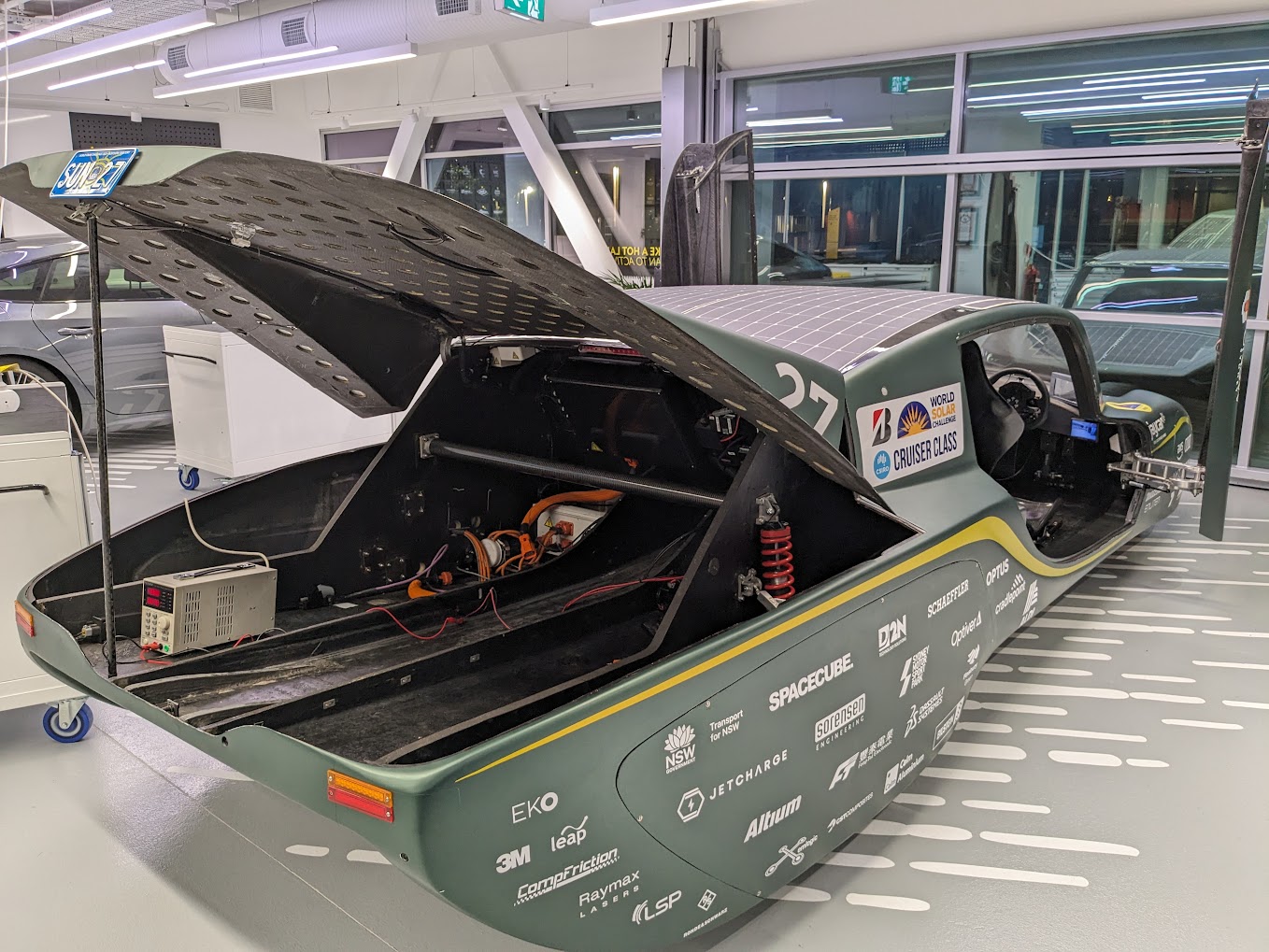 Sunswift 7 opened in the workshop, exposing internal electronics