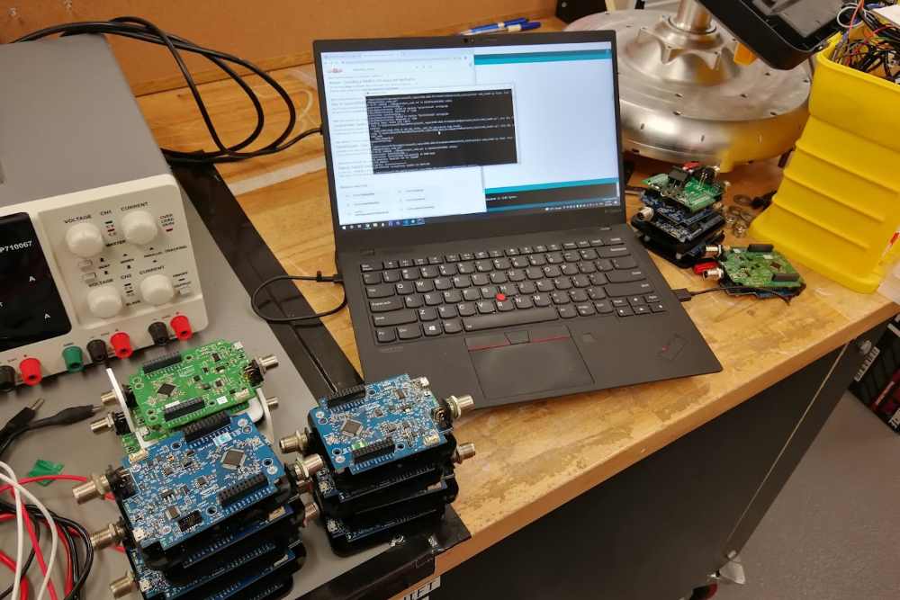 Bench setup flashing stacked microcontroller node boards by hand